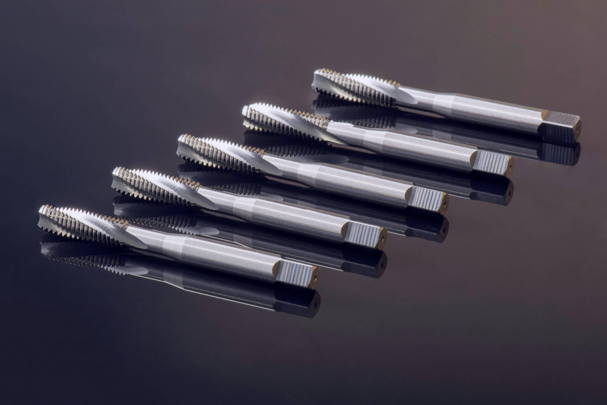 Spiral flute taps and dies